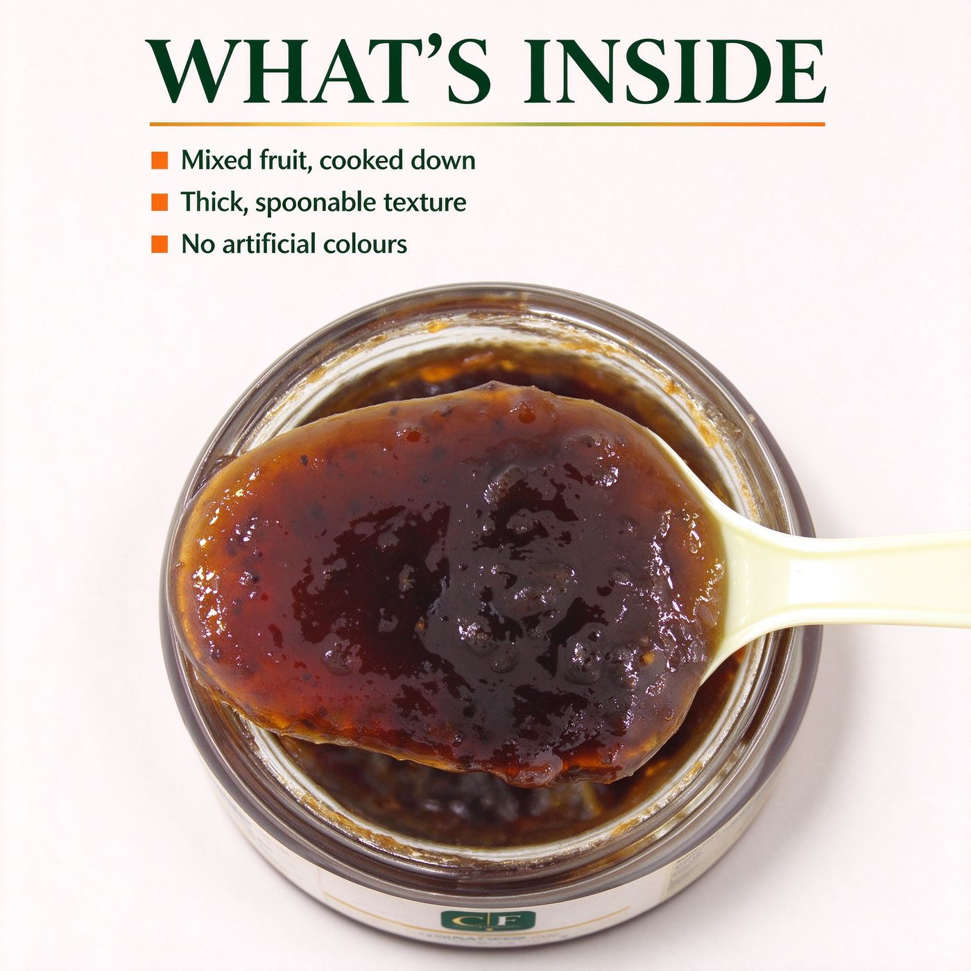 An open tin of mixed fruit jam with a spoon, seen from above