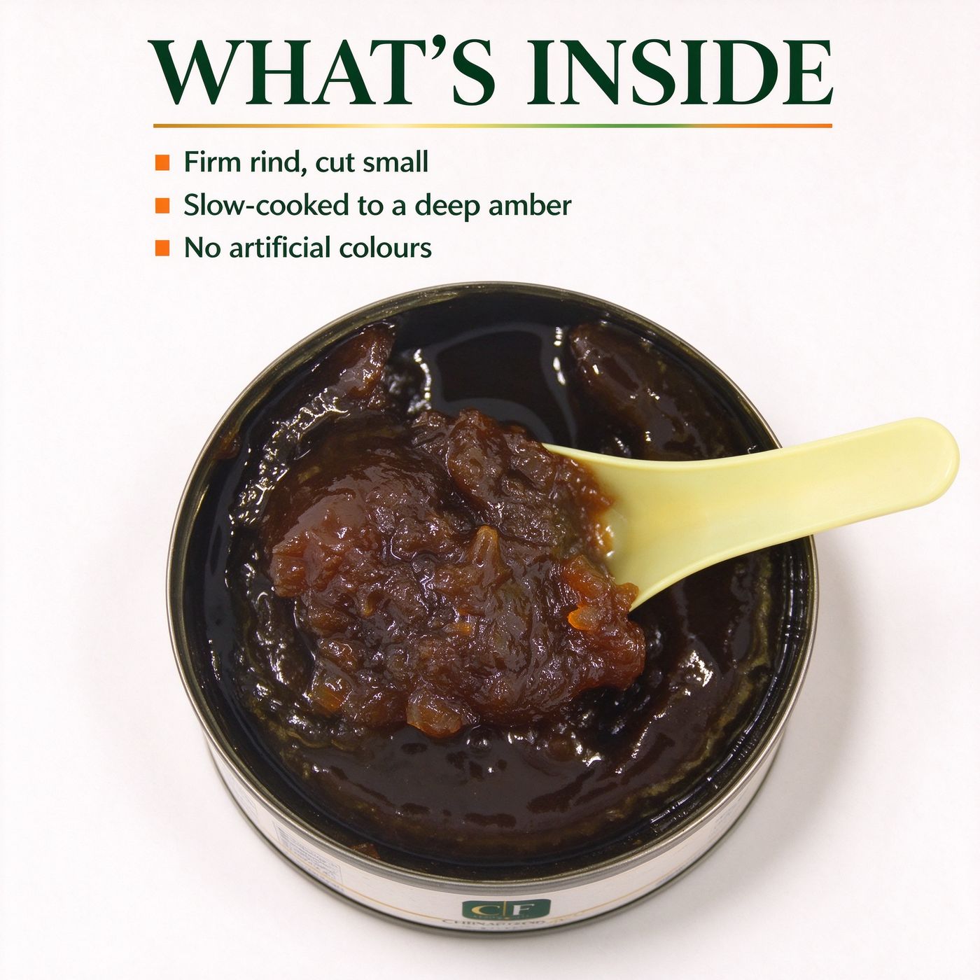 An open tin of watermelon jam with a spoon, seen from above